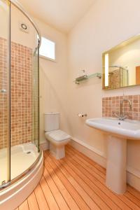 a bathroom with a toilet and a sink and a shower at 5 Bed in Pwllheli oc-1coedy in Abersoch +44 photos