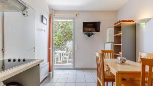 a kitchen and dining room with a table and chairs at L Ocean N11 2P4 in La Tranche-sur-Mer