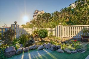 a backyard with a fence and a pond with rocks at 2Bi s Home Dalat 3 in Da Lat