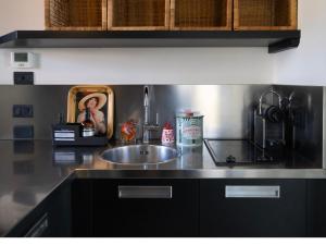 a kitchen with a sink and a counter top at BASTIA RF Suite up to 4 guests - in the heart of Scalo Romana, Olimpico, Prada, Bocconi and easy access Forum Assago, IEO, IED, Duomo, San Siro in Milan