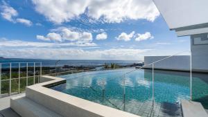 a swimming pool on the balcony of a building at Orient Luxury Hotel Kenting in Hengchun South Gate +44 photos
