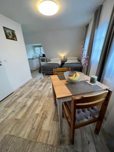 a living room with a table with a bowl of fruit on it at Aparts4ring 10, Nürburg in Nürburg