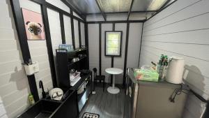 a small room with a desk and a stool in it at Secret Garden House - 2BR Cozy Home with Garden & Workspace in Ban Tai