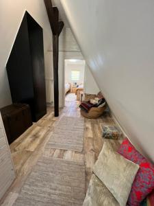 a attic room with a staircase with a bed and rug at Aparts4ring 10, Nürburg in Nürburg