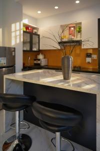 a kitchen with a counter with two bar stools at 2Bi s Home Dalat 3 in Da Lat
