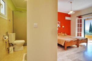 a bedroom with a bed and a toilet at Rhea Complex in Paleokastritsa +68 photos