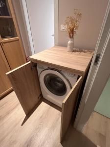 a washer and dryer in a utility room at Chianti's Secret Nest - Cozy home with sunset view in Impruneta