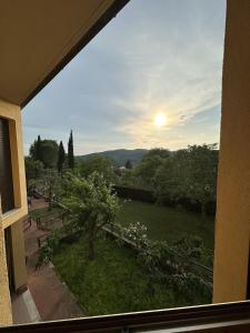 a view of a garden from a window of a building at Chianti's Secret Nest - Cozy home with sunset view in Impruneta