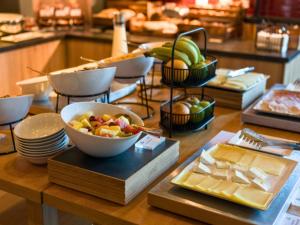 a table with a bowl of fruit and other food at B&B HOTEL Warrington in Warrington
