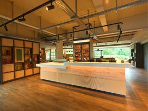 a bar in a large room with wooden floors at B&B HOTEL Warrington in Warrington