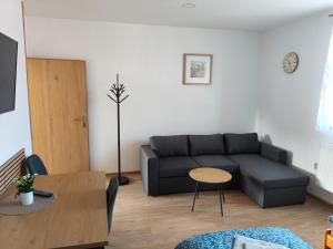 a living room with a couch and a table at Apartmán 38 in Opolany
