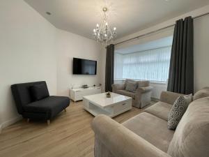 a living room with a couch and chairs and a tv at The Villas holiday homes in Horden
