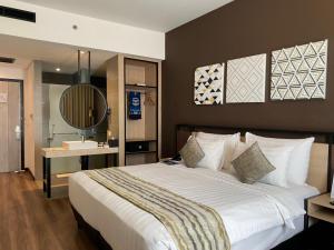a bedroom with a large bed and a bathroom at Muraya Hotel Aceh in Banda Aceh +32 photos