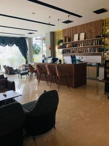 a lobby with chairs and a bar in a restaurant at Muraya Hotel Aceh in Banda Aceh