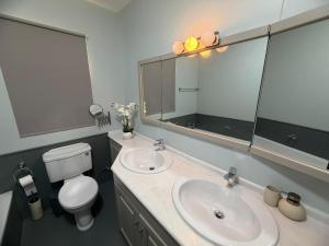 a bathroom with a sink and a toilet and a mirror at Vista Mare Sliema in Sliema +13 photos