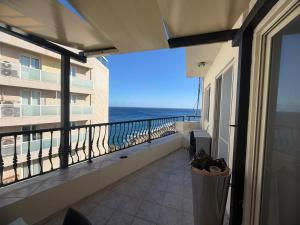 a balcony of a condo with a view of the ocean at Vista Mare Sliema in Sliema
