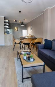 a living room with a couch and a table at MiTRa Luxury Apartments in Shumen