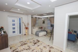 a living room with a couch and a room with a table at Greis Home in Maliq