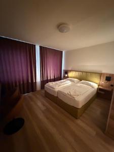 a bedroom with a large bed in a room at Turm Inn 24H Self Check In By H&H Hotels in Linz +26 photos
