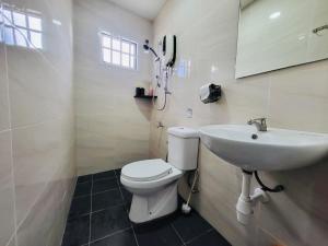 a bathroom with a toilet and a sink at Spacious Home in the Heart of Melaka for Families 10 pax, Chill & Relax at Extra Wide Balcony, COMFY HILL in Malacca