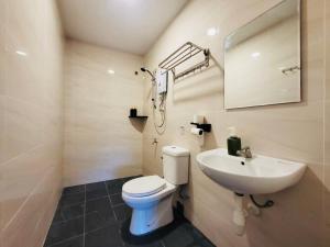 a bathroom with a white toilet and a sink at Spacious Home in the Heart of Melaka for Families 10 pax, Chill & Relax at Extra Wide Balcony, COMFY HILL in Malacca