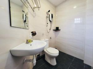 a bathroom with a sink and a toilet and a mirror at Spacious Home in the Heart of Melaka for Families 10 pax, Chill & Relax at Extra Wide Balcony, COMFY HILL in Malacca +52 photos