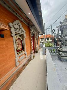 a building with a plaque on the side of it at Alena in Nusa Dua