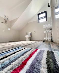 an attic room with a rug on the floor at Polelanka guest house in Mirissa +50 photos