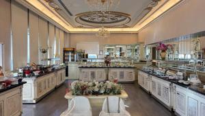 a large kitchen with a lot of counters and appliances at Demir Hotel in Diyarbakır