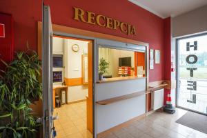 an entrance to a restaurant with a sign on the wall at Hotel Stadion in Kielce