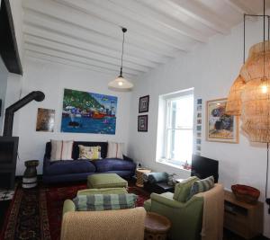 a living room with a blue couch and chairs at Majestic Secret in Cape Town