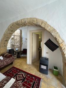 a room with a stone archway with a bed and a table at TOWER Hotel in Dana