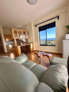a living room with a couch and a large window at Ibis Stays in Naziba