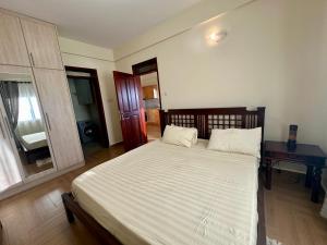 a bedroom with a large bed with white sheets at Ibis Stays in Naziba