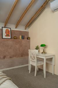 a room with a white table and a chair at Tool House - Great Estate Stay for Remote Work in Siddapur