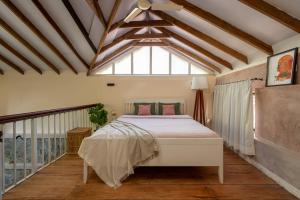 a bedroom with a bed and a window at Tool House - Great Estate Stay for Remote Work in Siddapur