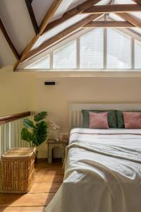 a bedroom with a bed and a large window at Tool House - Great Estate Stay for Remote Work in Siddapur