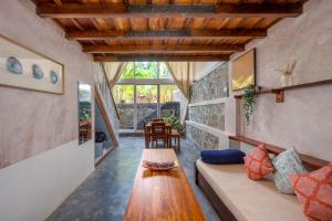 a living room with a couch and a table at Tool House - Great Estate Stay for Remote Work in Siddapur +59 photos