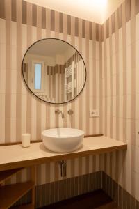 a bathroom with a white sink and a mirror at Maison Petronilla in Naples