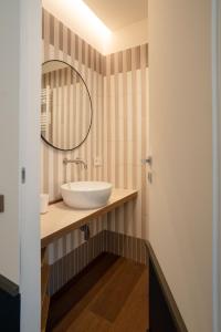 a bathroom with a sink and a mirror at Maison Petronilla in Naples +35 photos
