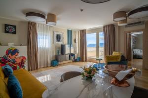 a living room with a table and a couch at Grand Hotel Alassio Beach & Spa Resort - The Leading Hotels of the World in Alassio