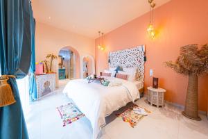 a bedroom with a large bed in a room at Suites Romantiques avec Jacuzzi - Marne-La-Vallée - Le Jardin De Vos Secrets in Mouroux +42 photos