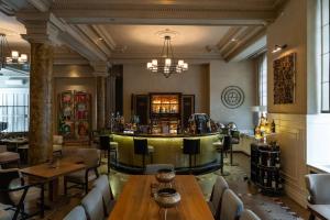 a bar in a restaurant with tables and chairs at The Bank Hotel Istanbul, a Member of Design Hotels in Istanbul