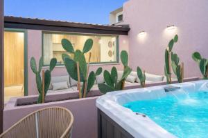 a hot tub on a balcony with cactus at Vico Trigona SicilyMyHome e jacuzzi riscaldata in Noto