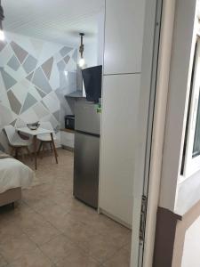 a kitchen with a refrigerator and a table at Galatia Studio in Thérissos