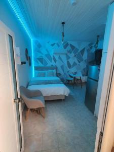 a blue bedroom with a bed and a blue ceiling at Galatia Studio in Thérissos