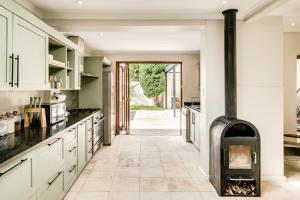 a kitchen with a wood stove in the middle at Song of Ascent in Cape Town