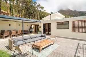 a house with a couch and a table on a patio at Song of Ascent in Cape Town