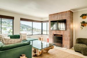 a living room with a couch and a fireplace at Song of Ascent in Cape Town