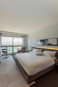 a bedroom with a large bed and a large window at The View - Saint George Hotel in Beirut +35 photos